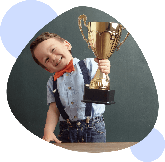 little boy holding a trophy
